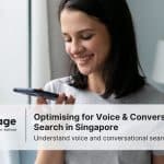 Photo of a lady using the voice search function on her phone, representing voice search SEO in Singapore